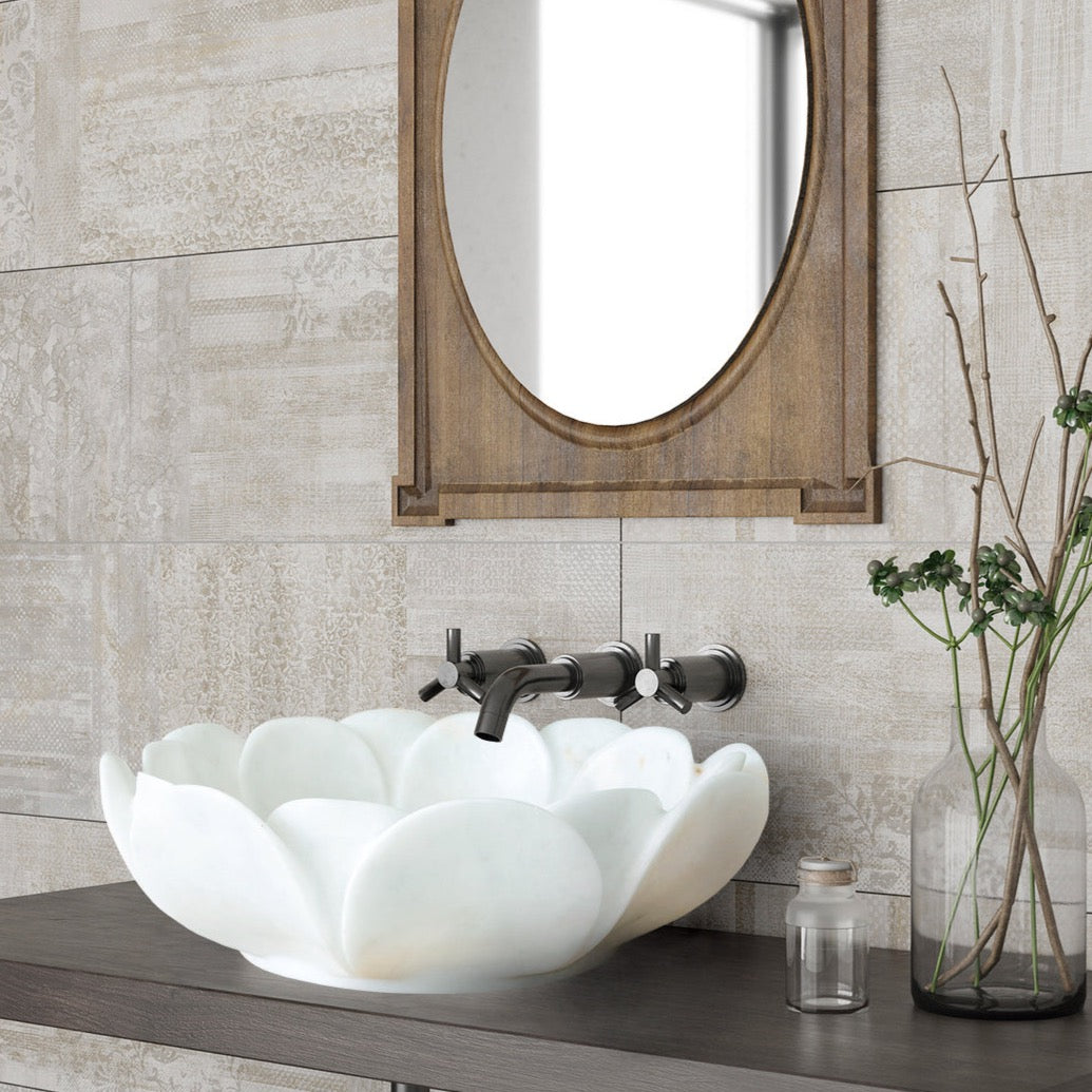 http://villohome.com/cdn/shop/products/Carrara-White-Marble-Stone-vessel-flower-shape-sink-NTRVS18-D17-H6-bathroom-view.jpg?v=1688993132