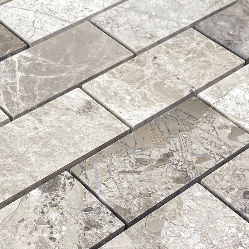 Silver shadow marble mosaic tile 2x4 brick on 12x12 mesh honed angle closeup product shot