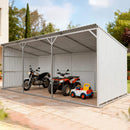 Metal carport with a motorcycle, ATV, and toy car inside on a sunny day.