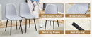 Table and chair set.79'x31.5' with X-shaped Black Metal Table Legs,Wood Grain Textured MDF Crossbeam.Paired With 10 Chairs Made Of Light Gray Lnen Fabric.Iron pipe spraying Legs.