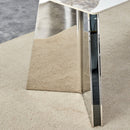 Table and chair set.63'x31.5x30' Luxurious Pandora patterned Sintered Stone Tabletop with Silver Stainless Steel Legs.Paried With 4 White PU Chairs with a vertical stripe design on the backrest.