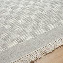 Clinten Solid and Border Ivory Area Rug