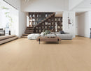 Modern living room with wooden flooring, bookshelf, and furniture. Byso