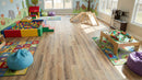 Children's playroom with toys and colorful rugs on a wooden floor
