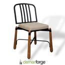 Chair with black metal back and wooden legs on a white background, featuring the Demarforge brand.
