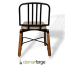 Chair with black metal frame and wooden legs on a white background, featuring the demarforge logo.