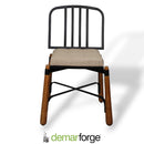 Chair with black metal frame and wooden legs on a white background, featuring the Demarforge logo.
