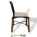 Chair with wooden legs and a cushioned seat on a white background, featuring the demarforge brand.