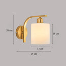 Classic brass glass wall sconce with frosted shade for bedroom