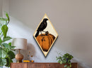 Illustrated crow perched on curling pumpkin Diamond Shaped Art Canvas Embossed Print with spooky autumn gothic Halloween flair