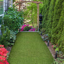 Artificial grass pathway leading through a garden with plants and flowers - LTRFPEME7.5X10-32MM66OZ