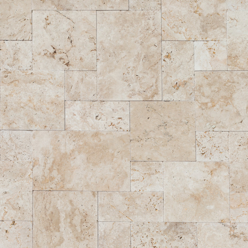 Light antique travertine pavers unfilled tumbled pattern top dry view
