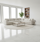Modern living room with a white sectional sofa, coffee table, and bookshelf.