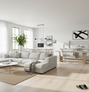 Modern living room with white sectional sofa, coffee table, and decor elements.