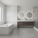 Modern bathroom with a freestanding bathtub, vanity, and round mirrors with lights.