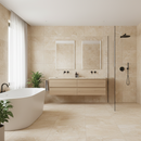 Modern bathroom with beige tiles, a freestanding bathtub, and a vanity.