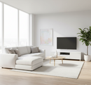 Modern living room with white sectional sofa, TV, and decor elements.