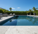 Pool area with lounge chairs, potted plants, and a clear blue sky.
