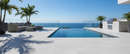 Outdoor pool area with lounge furniture and ocean view