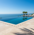 Infinity pool with ocean view and palm trees