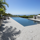 Modern pool area with palm trees and a clear blue sky