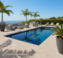 Outdoor pool area with lounge chairs, grill, and ocean view