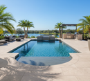 Outdoor pool area with lounge chairs, grill, and palm trees on a clear day.