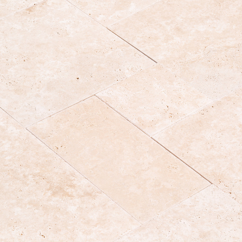 Miletos ivory travertine pavers unfilled tumbled pattern angle closeup view