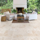 Miletos Ivory Travertine Pattern Tumbled Pavers - Full Truckload patio fireplace 2 armchairs and wooden coffee table