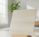 Light wood panel with a wooden base on a white surface, with a plant in the background.