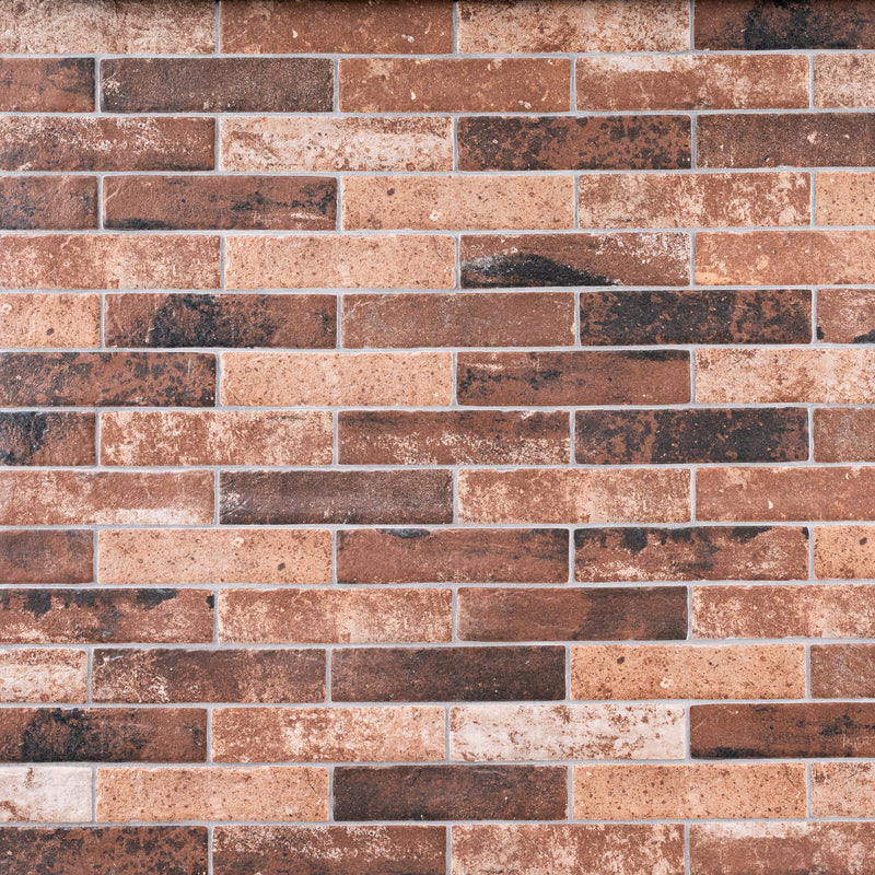 MSI brick collection capella red brick NCAPREDBRI5X10 glazed porcelain floor wall tile product shot multiple bricks dinning wall view 2