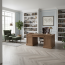 Home office with wooden desk, bookshelves, and armchair.