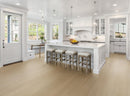 Modern kitchen with white cabinets, island, and stools. Amber Dusk