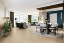 Modern living room with a dining area, plants, and large windows. Skyline