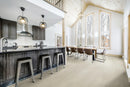 Modern kitchen with a dining area, lamps, and large windows. Mirage