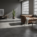 Modern living room with a brown leather sofa, coffee table, and large windows.