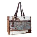 Myra Juniper Weekender Bag for Women with upcycled canvas and hairon hide with embossed leather detail