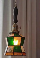 Teal blue glass pendant light with brass hardware for dining room