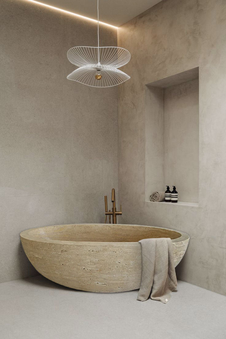Troia Light Travertine Bathtub Hand-carved from Solid Marble Block (W)32" (L)70" (H)20" installed modern bathroom brown towel on the edge copper faucet wide view