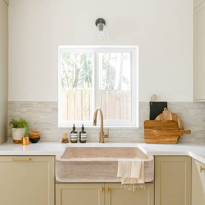 Troia Light Travertine Rectangular Farmhouse Kitchen Sink Honed and Filled (W)18" (L)27.5" (H)7" installed bright and modern kitchen white countertop and light green cabinets