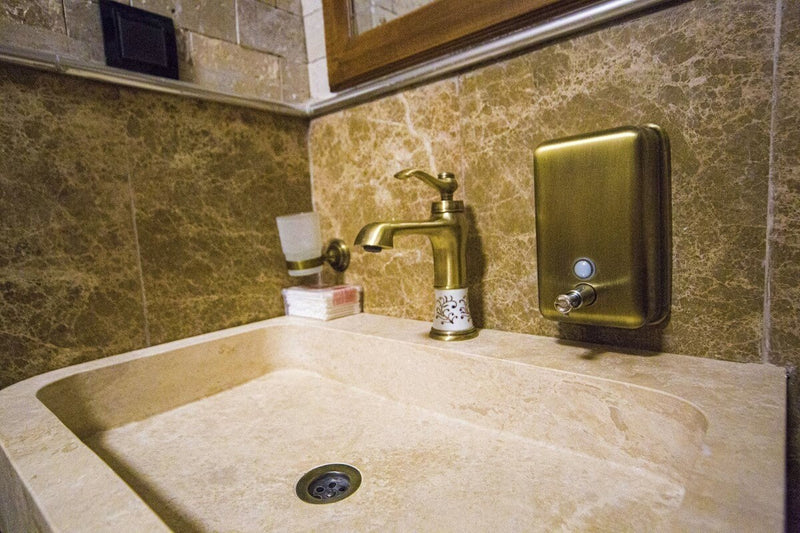 Troia Light Travertine Pedestal Stand-alone Sink Honed and Filled (W)19" (L)26" (H)33.5" installed hotels bathroom emperador marble on walls closeup view