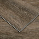 Close-up of a brown vinyl floor tile with a wood grain pattern.