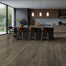 Modern kitchen with wooden floor and island bar stools.