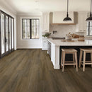 Modern kitchen with wooden flooring, white cabinets, and a island.