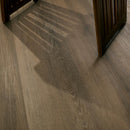 Close-up of a wooden floor with a door frame in the background