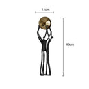 Abstract black and gold human figurine golden ball holder living room