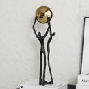 Abstract black and gold human figurine golden ball holder living room