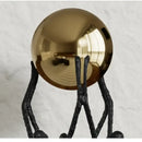 Abstract black and gold human figurine golden ball holder living room