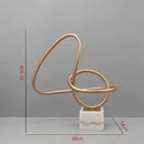 Abstract gold line geometric metal sculptures on marble living room decor