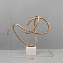 Abstract gold line geometric metal sculptures on marble living room decor
